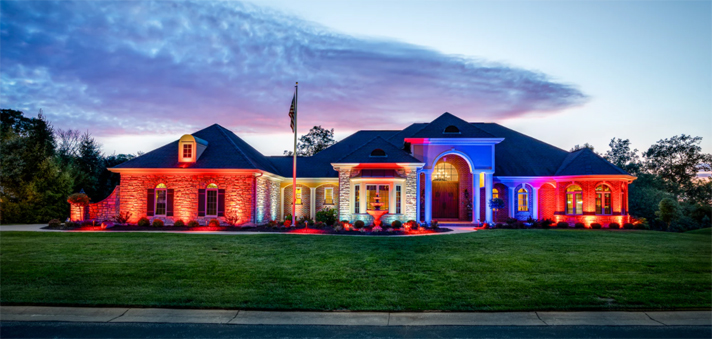 House with colored lights shining the front